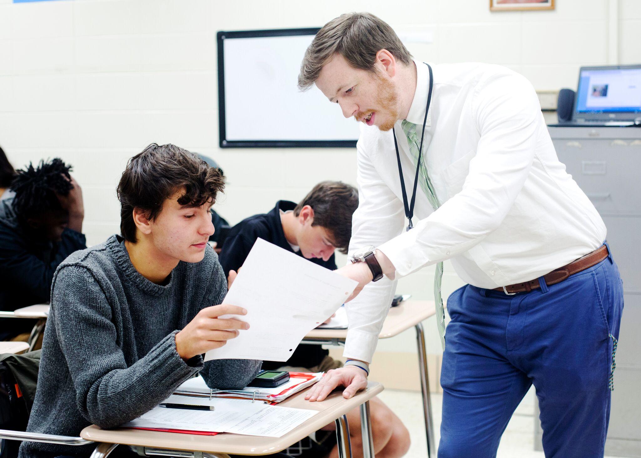 Teacher helping student with class assignment at Starkville High Schools
