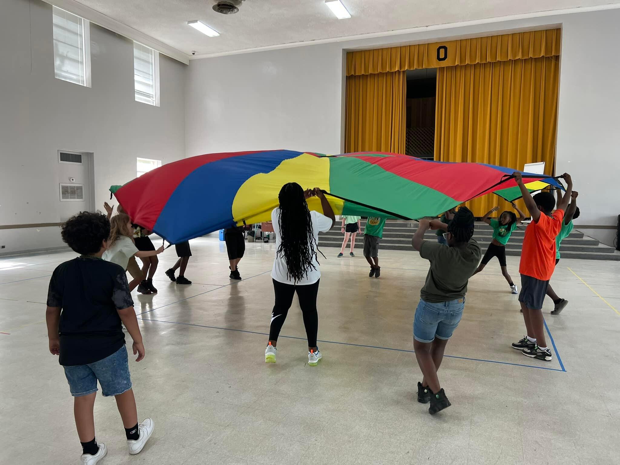 Overstreet students play with a parachute in the gym during Physical Education