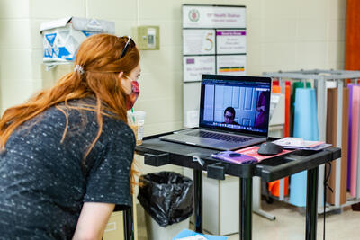 Teacher helping a virtual learner